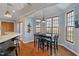 Bright dining area with a modern light fixture, hardwood floors and big windows for ample natural light at 12608 E 86Th St, Indianapolis, IN 46236
