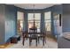 Charming dining room with a dark wood table set in front of bright windows with views of the outdoors at 12608 E 86Th St, Indianapolis, IN 46236