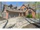Elegant brick home featuring a two-car garage, covered entryway, and a well-kept lawn, all under a bright sky at 12608 E 86Th St, Indianapolis, IN 46236