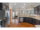 Modern kitchen featuring stainless steel appliances, dark cabinets, and sliding doors to the deck at 12608 E 86Th St, Indianapolis, IN 46236