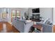 Cozy living room featuring a black fireplace, hardwood floors, and comfortable gray sofas, perfect for relaxation at 12608 E 86Th St, Indianapolis, IN 46236