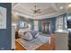 Spacious main bedroom with tray ceiling, ceiling fan, en-suite bathroom, and outdoor access at 12608 E 86Th St, Indianapolis, IN 46236