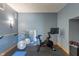 Home gym featuring exercise bike, mirror, weights, and workout accessories for fitness and wellness at 12608 E 86Th St, Indianapolis, IN 46236