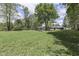 Expansive backyard features lush lawn and mature trees, creating a serene and private outdoor space at 1301 Stafford Rd, Plainfield, IN 46168