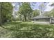 Expansive backyard features lush green grass, mature trees, and outdoor seating at 1301 Stafford Rd, Plainfield, IN 46168