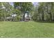 Lush backyard with mature trees offers a tranquil setting for outdoor enjoyment and relaxation at 1301 Stafford Rd, Plainfield, IN 46168