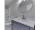Bathroom features vanity with oval mirror and combination shower and tub at 1301 Stafford Rd, Plainfield, IN 46168