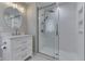 Updated bathroom features a glass shower, white vanity, and modern lighting at 1301 Stafford Rd, Plainfield, IN 46168