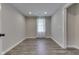 Finished bedroom boasts gray walls and plank flooring, white trim, recessed lights, and a bright window at 1301 Stafford Rd, Plainfield, IN 46168