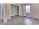 Neutral bedroom features wood floors, natural light, and an open door to a closet at 1301 Stafford Rd, Plainfield, IN 46168