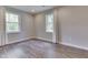 Cozy bedroom with wood floors, neutral paint, and two large windows with natural light at 1301 Stafford Rd, Plainfield, IN 46168