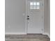 Interior view of the entryway featuring a paneled white door and modern hardware at 1301 Stafford Rd, Plainfield, IN 46168