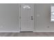 The front door has decorative glass, complemented by neutral walls and gray wood floors at 1301 Stafford Rd, Plainfield, IN 46168