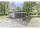 Charming home exterior boasts a cozy porch, complemented by gravel landscaping and well-maintained surroundings at 1301 Stafford Rd, Plainfield, IN 46168