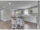 Updated kitchen features white cabinets, stainless appliances, an island with seating, and wood flooring at 1301 Stafford Rd, Plainfield, IN 46168
