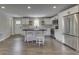 Bright kitchen features white cabinets, stainless appliances, and an island with seating at 1301 Stafford Rd, Plainfield, IN 46168