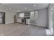 A modern space with an open kitchen, including stainless steel appliances and a sliding glass door to the backyard at 1301 Stafford Rd, Plainfield, IN 46168