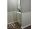 A compact laundry space features stacked washer and dryer for space saving convenience at 1301 Stafford Rd, Plainfield, IN 46168
