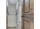 Convenient laundry area features stacked washer and dryer units and tiled wall at 1301 Stafford Rd, Plainfield, IN 46168