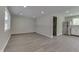 An open living area with gray wood flooring and neutral paint creates a bright and inviting space at 1301 Stafford Rd, Plainfield, IN 46168