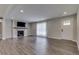 Open living room with luxury vinyl plank flooring, a modern fireplace, and large bright windows at 1301 Stafford Rd, Plainfield, IN 46168