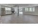 Open-concept living area with gray wood floors, updated kitchen, and ample natural light at 1301 Stafford Rd, Plainfield, IN 46168