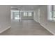 Spacious living room boasts abundant natural light, neutral paint, and stylish gray wood flooring at 1301 Stafford Rd, Plainfield, IN 46168