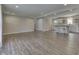 Open-concept living room and kitchen features wood floors, neutral paint, and recessed lighting at 1301 Stafford Rd, Plainfield, IN 46168
