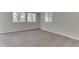 A modern living room featuring hardwood floors, neutral paint, and natural light from multiple windows at 1301 Stafford Rd, Plainfield, IN 46168