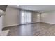 Bright living area with modern fireplace, large window with sheer curtains and luxury vinyl plank flooring at 1301 Stafford Rd, Plainfield, IN 46168