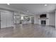 Open-concept living space featuring modern white cabinets, stainless steel appliances, and a fireplace at 1301 Stafford Rd, Plainfield, IN 46168