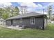 Home's rear exterior showing siding, well-maintained yard, and utility connections at 1301 Stafford Rd, Plainfield, IN 46168