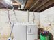 Unfinished basement with modern washer and dryer appliances and utility connections at 1408 W Jackson St, Muncie, IN 47303