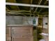 Basement electrical panel and exposed wooden joists with utilities visible at 1408 W Jackson St, Muncie, IN 47303