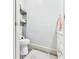 Small half bath offering modern toilet, vanity, and storage shelving in tight space at 1408 W Jackson St, Muncie, IN 47303