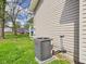 Exterior of home with modern A/C unit situated in grassy area near home at 1408 W Jackson St, Muncie, IN 47303