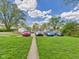 Wide exterior shot of home featuring a well-manicured lawn and ample parking space for multiple vehicles at 1408 W Jackson St, Muncie, IN 47303