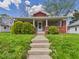 Charming craftsman-style home with a welcoming front porch and well-maintained lawn at 1408 W Jackson St, Muncie, IN 47303