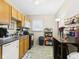 Functional kitchen featuring wood cabinets, black appliances, and a cozy dining area at 1408 W Jackson St, Muncie, IN 47303