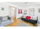 Bright living room with hardwood floors, comfortable seating, and a cozy ambiance at 1408 W Jackson St, Muncie, IN 47303