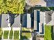 Overhead view shows a blue home nestled between neighboring houses and leafy trees at 1417 E Michigan St, Indianapolis, IN 46201