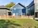 Backyard of a blue home featuring a wood fence and grassy area, perfect for outdoor activities at 1417 E Michigan St, Indianapolis, IN 46201