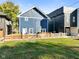 Lawn area with a view of the house, a wooden fence and the neighboring homes at 1417 E Michigan St, Indianapolis, IN 46201