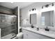Modern bathroom features double sinks, sleek hardware and tiled shower at 1417 E Michigan St, Indianapolis, IN 46201