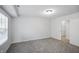 A bedroom with neutral colored walls, carpet, and trim at 1417 E Michigan St, Indianapolis, IN 46201