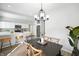 Dining area with a modern light fixture open to the kitchen with a breakfast bar and stainless steel appliances at 1417 E Michigan St, Indianapolis, IN 46201
