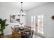 Light dining room with a black table, chairs and double doors to outdoor space for easy entertaining at 1417 E Michigan St, Indianapolis, IN 46201