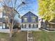 Inviting two-story home with a covered porch and mature trees in a desirable neighborhood at 1417 E Michigan St, Indianapolis, IN 46201