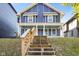 Charming two-story home featuring a welcoming front porch and well-maintained landscaping at 1417 E Michigan St, Indianapolis, IN 46201