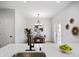 Bright and modern kitchen with white cabinetry, quartz countertops, updated lighting, and a view of the dining area at 1417 E Michigan St, Indianapolis, IN 46201